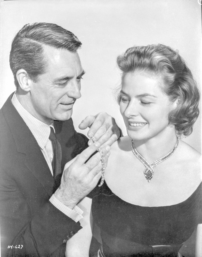 Indiscreet photo print of a man in black suit and woman with necklace