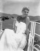 Rita Hayworth wearing a wedding gown looking sideways in a photo print.