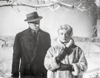 Imitation Of Life photo print featuring a lady in a furry coat and a man in a black suit with hat.