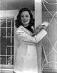 Geraldine Fitzgerald smiling in doctor's uniform photo print.