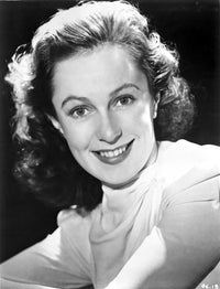 Geraldine Fitzgerald smiling portrait photo print in long sleeve top.