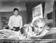 Home Before Dark photo print featuring a lady lying and a man in a long sleeve polo.