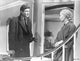 Home Before Dark Man Talking to Lady photo print showcasing a man and woman in conversation.