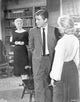 Home Before Dark photo print featuring man in suit talking to two ladies.