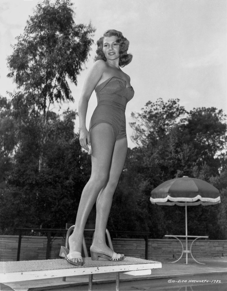 Rita Hayworth standing on diving board in swimming suit photo print