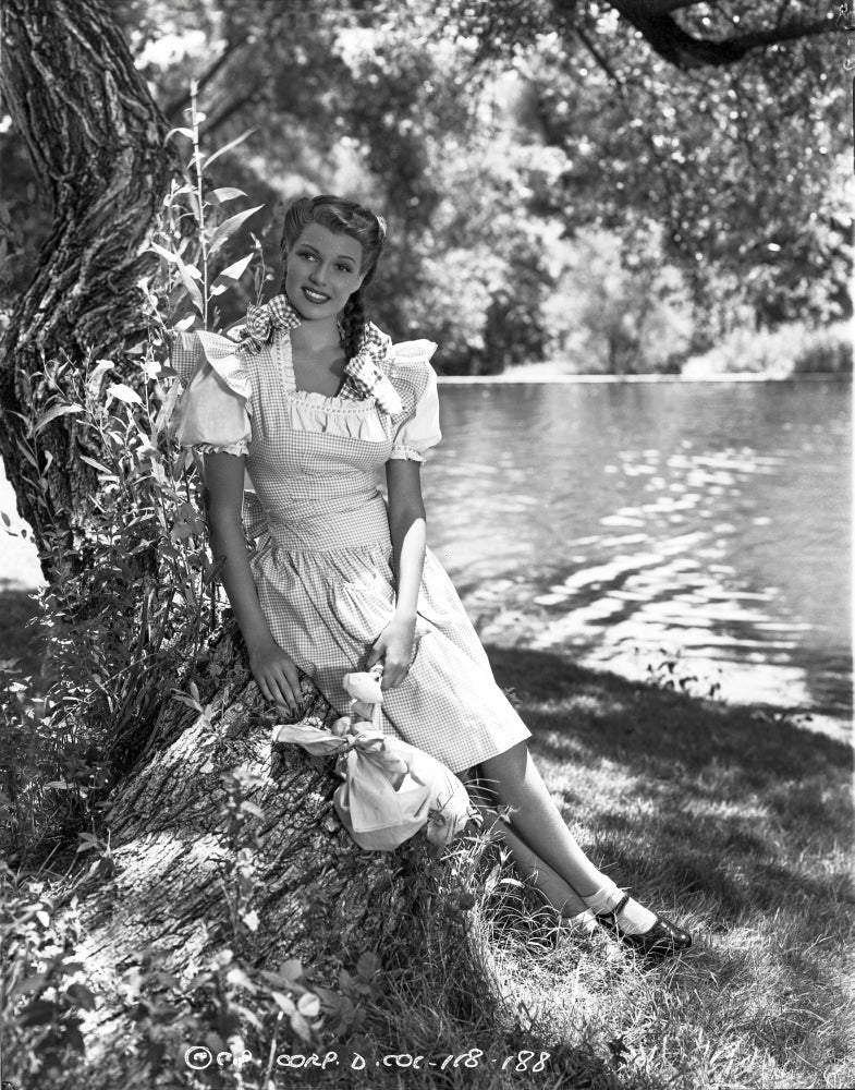 Rita Hayworth posed photo print showcasing classic Hollywood glamour.