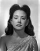 Carol Forman photo print wearing an embroidered dress with earrings.