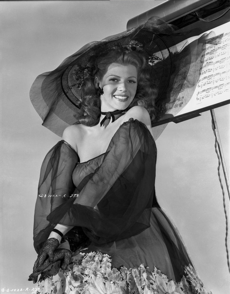 Photo print of Rita Hayworth in a black dress and hat, a classic Hollywood icon.