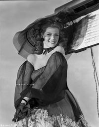 Photo print of Rita Hayworth in a black dress and hat, a classic Hollywood icon.