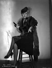 Eva Gabor sitting in furry shawl and dark dress photo print.