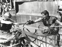 Black and white photo print of Charlton Heston in a horse-drawn vehicle