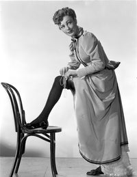 Virginia Grey photo print of woman fitting in her stockings on chair.