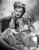Virginia Grey sitting on a chair in a shiny dress photo print
