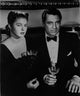 Classic photo print of a notorious couple holding wine glasses.