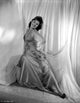 Barbara Hale sitting elegantly in a silk dress photo print.
