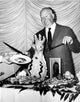 Alfred Hitchcock in a Black Suit and Tie Photo Print