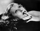 Lillian Harvey portrait photo print 'Looking Up with Finger on Lips'.
