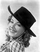 Jennifer Holt smiling portrait photo print in checkered top and hat.