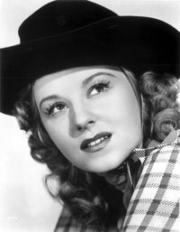 Jennifer Holt portrait photo print in checkered top and hat.
