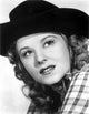 Jennifer Holt portrait photo print in checkered top and hat.