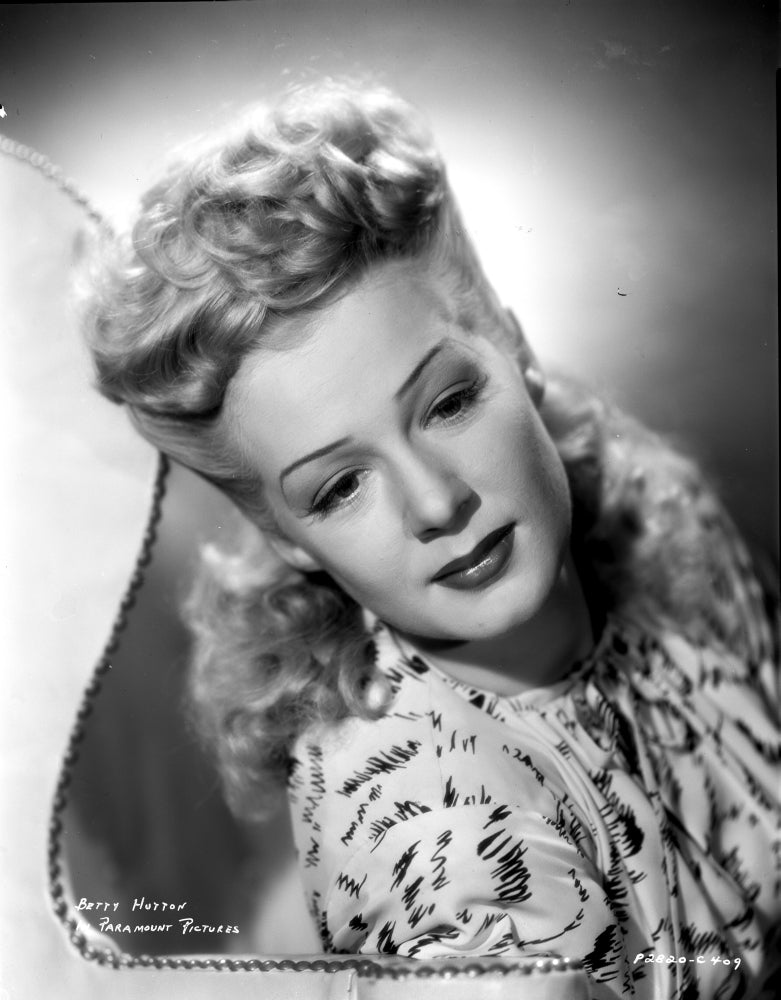 Betty Hutton portrait photo print showcasing her charm in a printed dress.