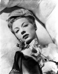 Betty Hutton Lying on a Couch with Flowers Photo Print