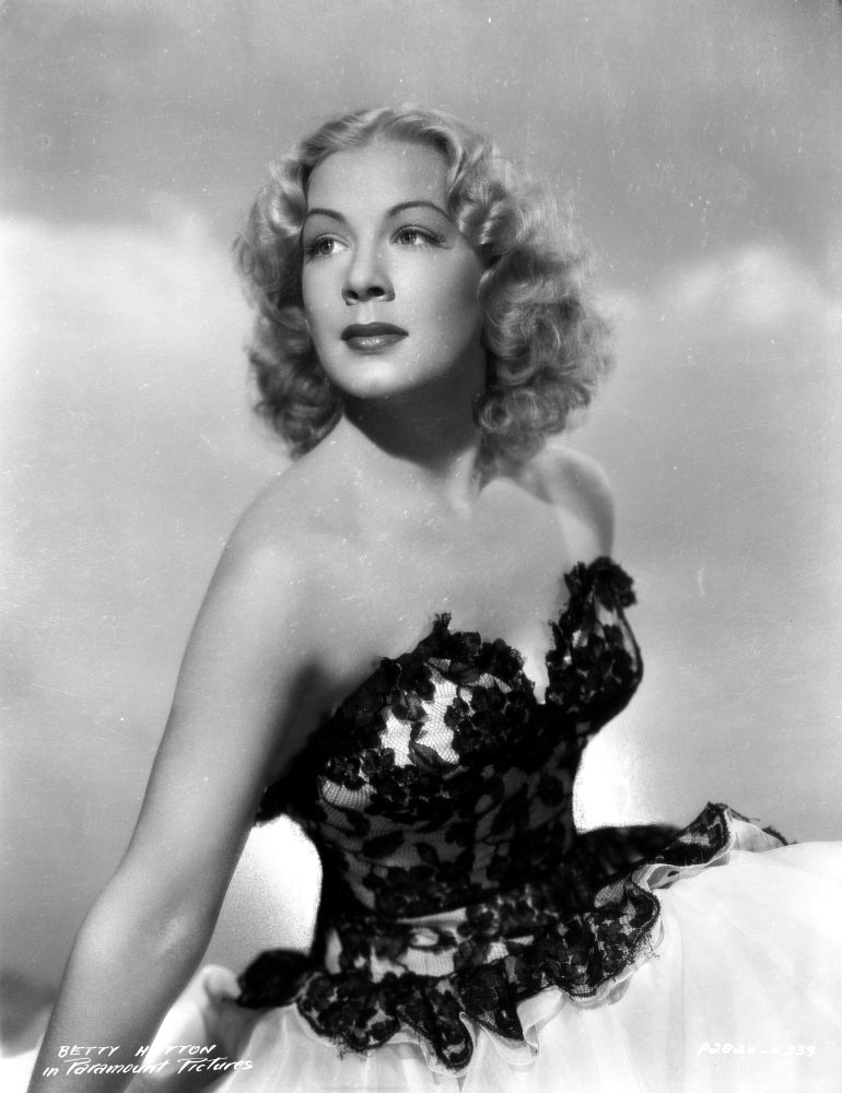 Betty Hutton sitting in an embroidered top photo print