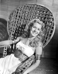 Brenda Joyce sitting on a handcrafted chair smiling photo print