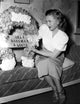 Priscilla Lane reading on a couch photo print