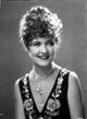 Laura La Plante smiling in a beaded sleeveless top photo print.