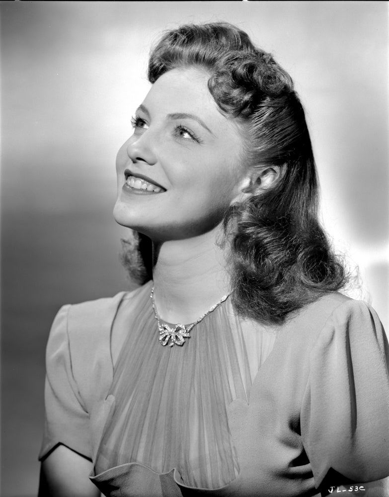 Joan Leslie Looking Up and Smiling Photo Print
