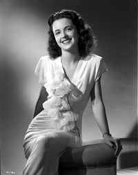 Vickie Lester seated in a ruffled dress smiling - photo print