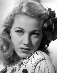 Audrey Long portrait photo print with embroidered top and ribbon headpiece.