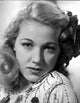 Audrey Long portrait photo print with embroidered top and ribbon headpiece.