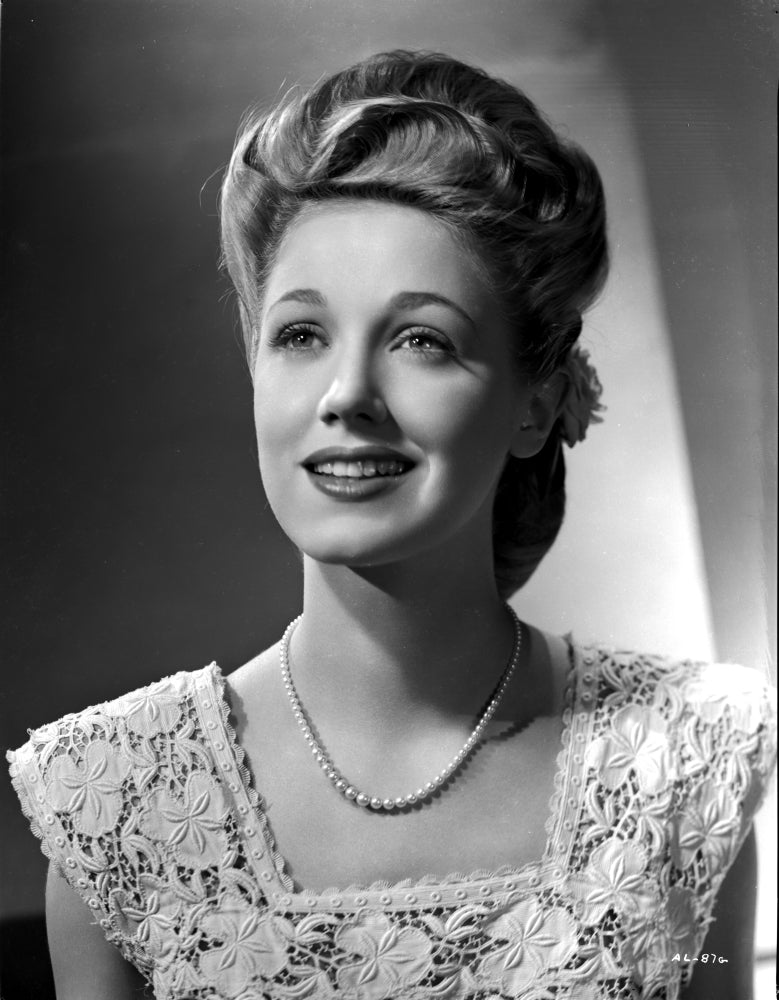 Audrey Long smiling in a lace dress with pearl necklace photo print