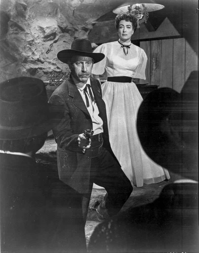 Johnny Guitar photo print featuring a man in a black suit pointing a gun with a woman in a white dress.