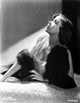 Ida Lupino lying on a soft cloth with a furry shawl photo print