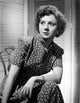 Betty Lynn seated in a black short sleeve polka dot dress photo print