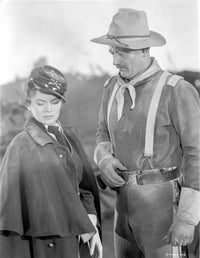 She Wore a Yellow Ribbon photo print of a man with a hat and woman talking.