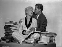 Born Yesterday Photo Print featuring a man and woman with books on a table.