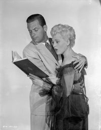 Born Yesterday photo print featuring a man and woman reading against a white background.