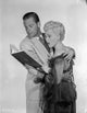 Born Yesterday photo print featuring a man and woman reading against a white background.
