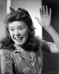 Marcy McGuire smiling photo print showing hand gesture