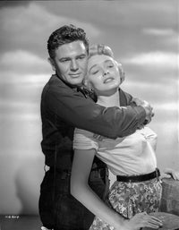 Breaking Point photo print featuring a man in a long sleeve polo and a woman in a printed skirt.