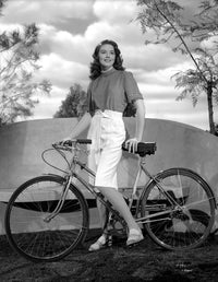 Dorothy Malone on a printed top holding a bicycle photo print