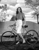 Dorothy Malone on a printed top holding a bicycle photo print