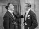 Damsel In Distress photo print featuring two men in suits, a captivating artwork.