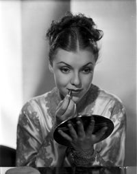Margo applying lipstick photo print showcasing elegance and beauty.
