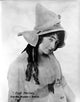 Enid Markey Portrait Photo Print featuring curly hair and ruffled top.