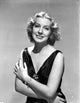 Gertrude Michael smiling photo print in V-neck dress